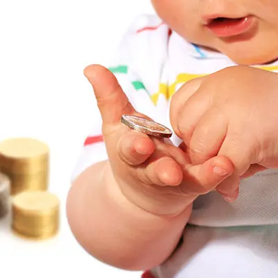 Image of infant holding money