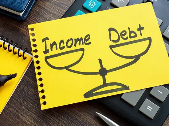 Image of a drawing of a balancing scale with the words debt and income on either side