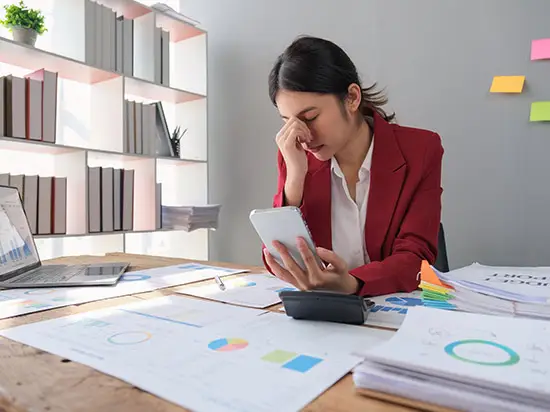 Image of stressed woman with bills