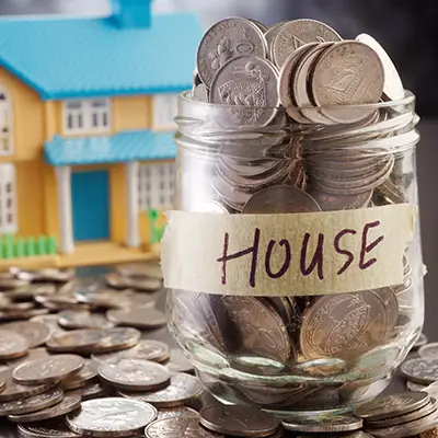 Image of jar full of coins labeled HOUSE