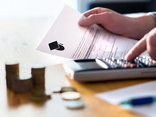 Image of man using calculator